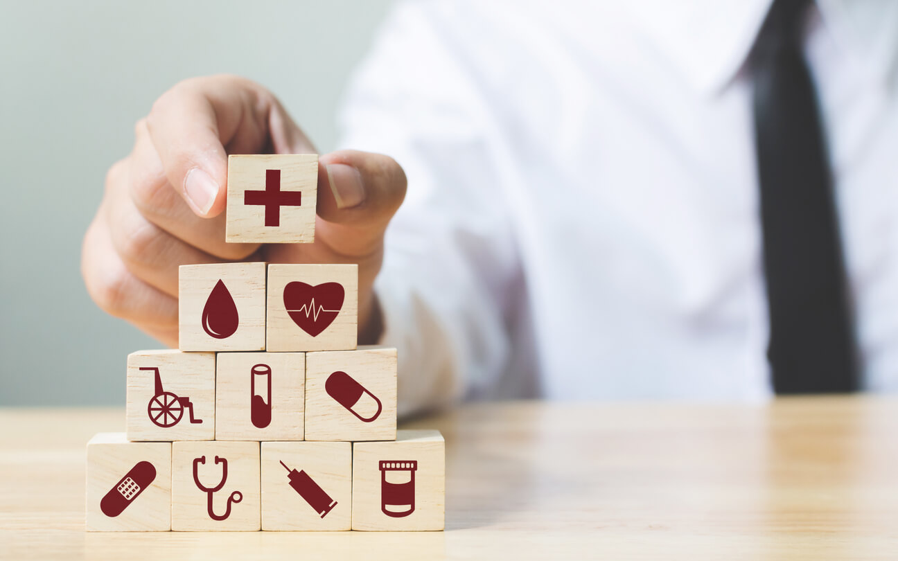 Businessman hand arranging wood block stacking with icon healthcare medical, Insurance for your health concept
